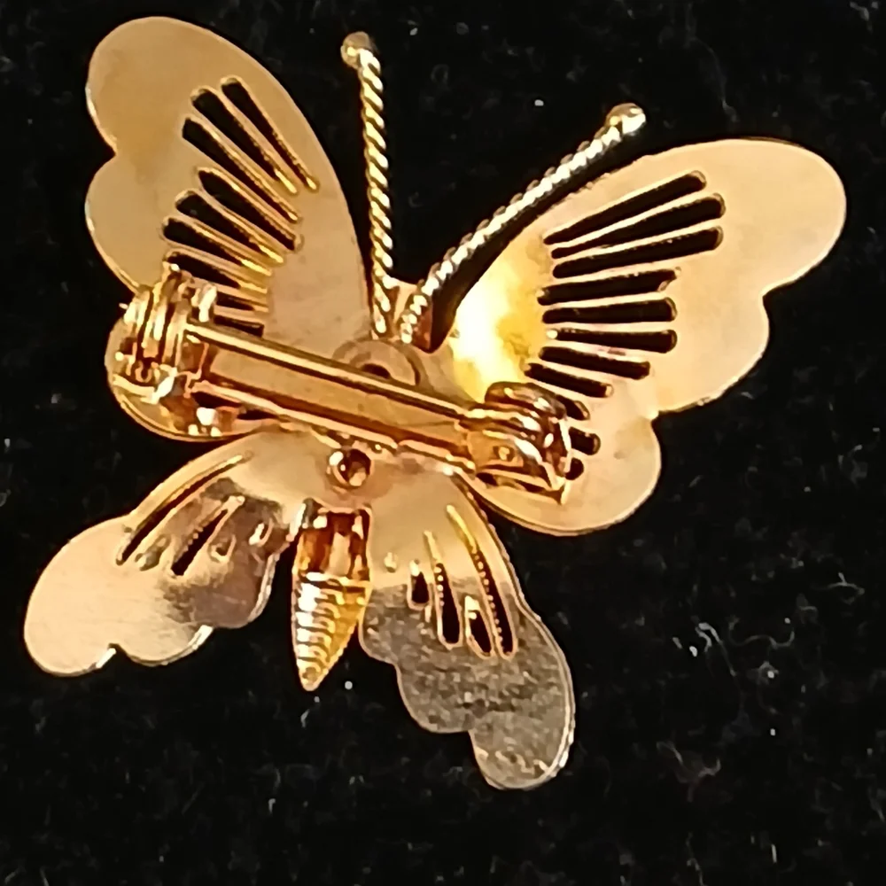 Vintage goldtone filigree butterfly brooch with pink accents